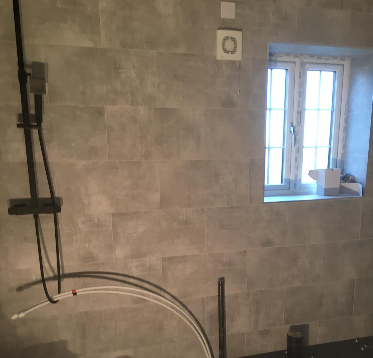 Concrete-effect shower room, during