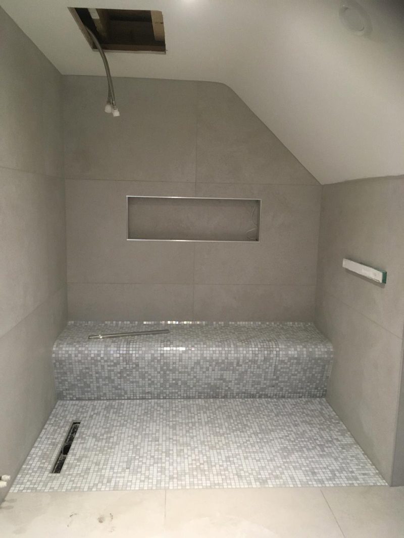 Walk-in shower with mosaic bench