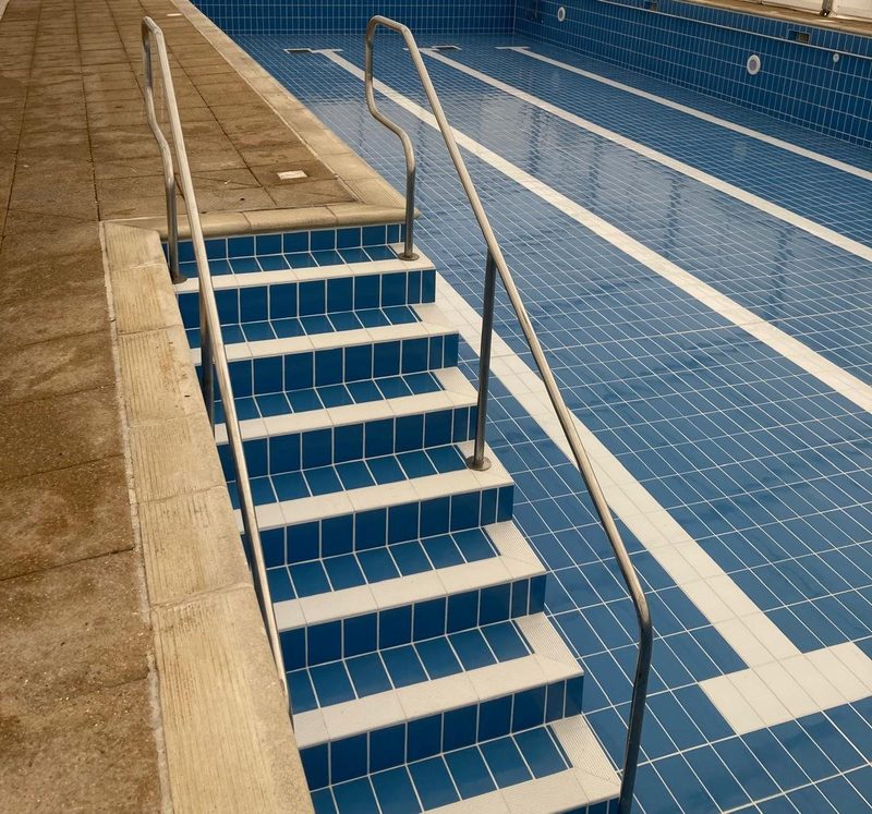 Full-width tiled pool steps with white nosings