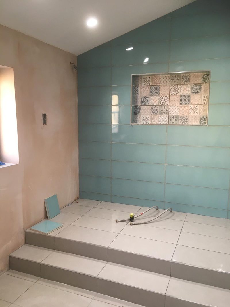 Teal wall with tiled steps